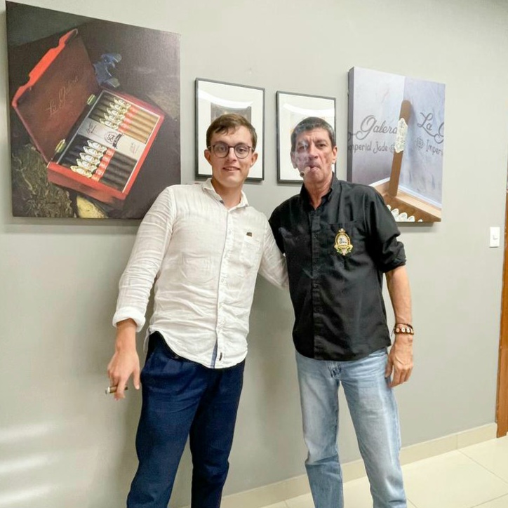 Jochy Blanco at Tabacalera Palma with cigar pictures in the background